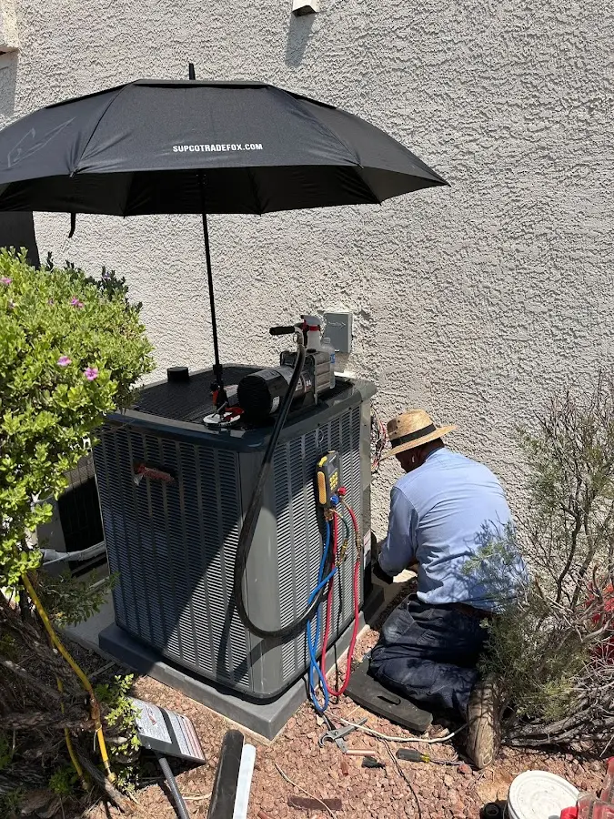HVAC technician performing outdoor AC maintenance in Amarillo